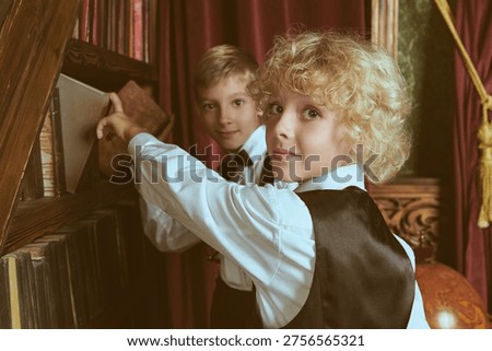Two private school students choosing books in a classic library interior. British education style, curiosity, friendship and elite academic atmosphere.