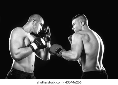 Two professional boxer isolated on black background, black and white photography