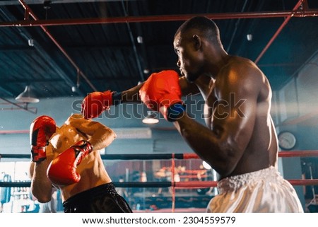 Two professional boxers are fighting on boxing ring, sportsmen boxing in the fight on square stage, or sport exercising with trainer at boxing and self defense lesson studio background, Thai Box match