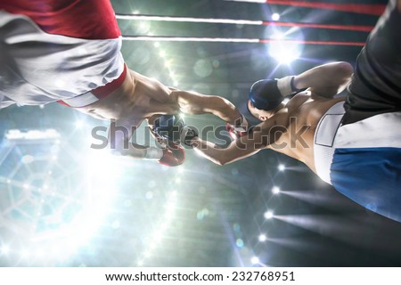 Two professional boxers are fighting on the grand arena