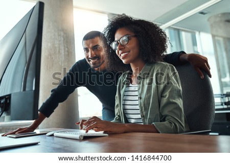 Two professional business people working together in office