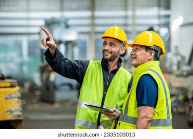 Two professional engineer worker technician assistant in helmet inspection check old machine construction factory with colleague manager. check old machinery production construction operating