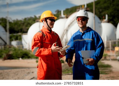 two professional engineer, worker, technician Chemical and gas storage safety inspection concept. Two industrial engineers checking quality and operations at chemical storage tanks. safety, engineer,