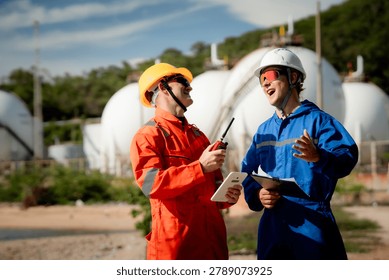 two professional engineer, worker, technician Chemical and gas storage safety inspection concept. Two industrial engineers checking quality and operations at chemical storage tanks. safety, engineer,