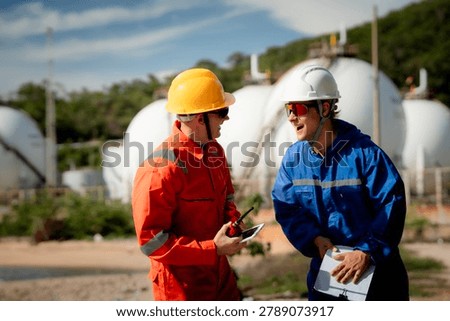 two professional engineer, worker, technician Chemical and gas storage safety inspection concept. Two industrial engineers checking quality and operations at chemical storage tanks. safety, engineer,