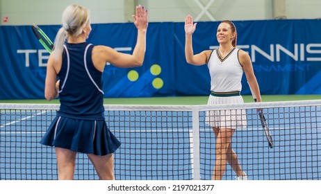 Two Professional Female Tennis Players Shake Hands After Successful Match Game Played on a Championship. Successful Woman Athletes Greet Each Other Over the Net. Sportsmanship, Competition. - Powered by Shutterstock