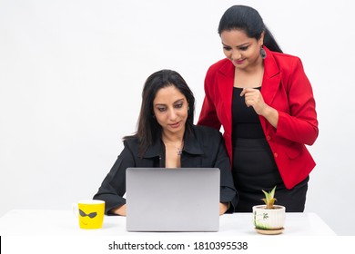 Two Professional Indian Women Working On Computer While Wearing Covid Protection Mask, Work From Home, Corporate Employees Holding Video Meeting With Client.