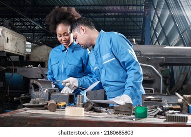 Two professional industry workers teams in safety uniforms and engineers' partners worked with metalwork tools, checked mechanical precision for lathe machines, and workshops in manufacturing factory. - Shutterstock ID 2180685803