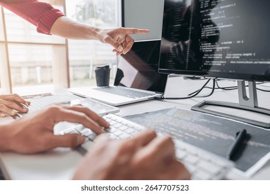 Two professional programmer cooperating and working on web site project in a software developing on desktop computer at company, codes and typing data code, Programming with HTML, PHP and javascript.