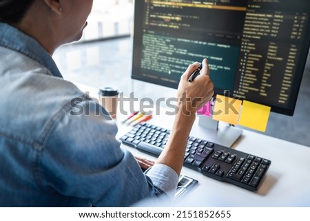 Two professional programmer cooperating and working on web site project in a software developing on desktop computer at company, codes and typing data code, Programming with HTML, PHP and javascript.