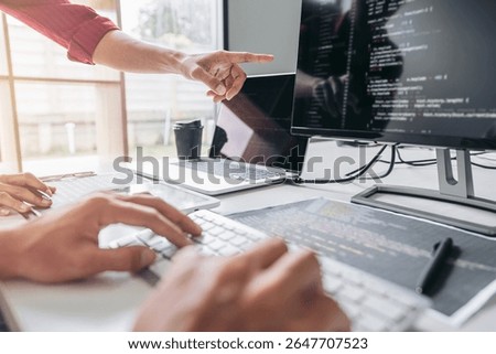 Two professional programmer cooperating and working on web site project in a software developing on desktop computer at company, codes and typing data code, Programming with HTML, PHP and javascript.