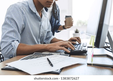 Two professional programmers cooperating at Developing programming and website working in a software develop company office, writing codes and typing data code. - Shutterstock ID 1383872627