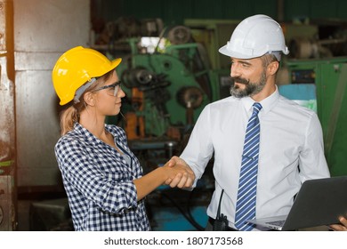 Two Professional Technician Engineers Are Making A Handshake After Reaching An Agreement For The Purchase Of Large Industrial Machinery.