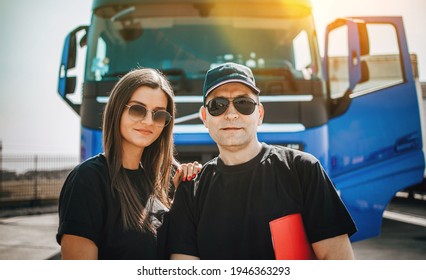 Two Professional Truck Drivers Stand In Front Of The Big Truck. They Talk And Perform A Technical Inspection Of The Vehicle Before Next Drive. Professional Transportation Concept.