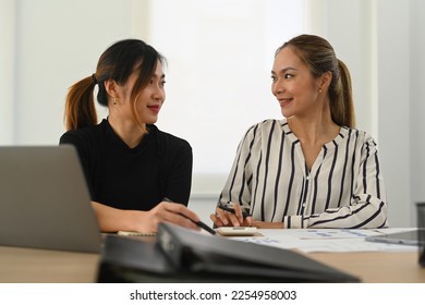 Two professionals business women discussing project developing financial research at co working in modern office - Shutterstock ID 2254958003