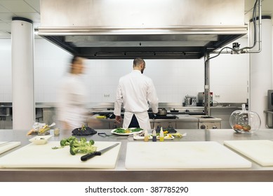 Two professionals chefs cooking together in a kitchen. - Powered by Shutterstock