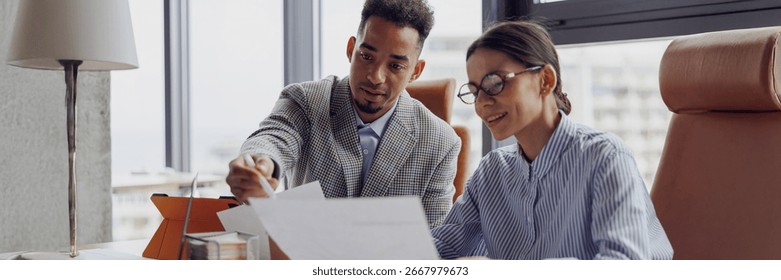 Two professionals discuss essential documents in a modern office to enhance collaboration and productivity