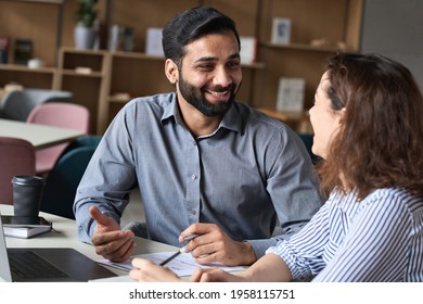 Two Professionals - Happy Smiling Indian Hr Manager And Latin Young Female Colleague At Office Meeting Having Fun. Mentoring Hispanic Male Teacher And Female Student In Multiethnic Creative Space.