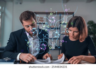 Two professionals review documents while digital network graphics overlay the scene. Office background. Concept of technology and data analysis - Powered by Shutterstock