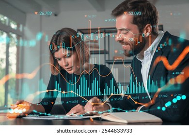 Two professionals reviewing financial documents with digital data graphs overlayed, set in a modern office. Concept of business analysis - Powered by Shutterstock