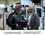Two professionals reviewing technical data in a modern industrial equipment environment
