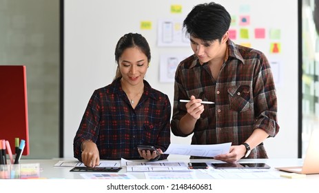 Two professionals web developers are working on software development and using modern devices at office.