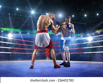 Two professionl boxers are fighting on the grand arena