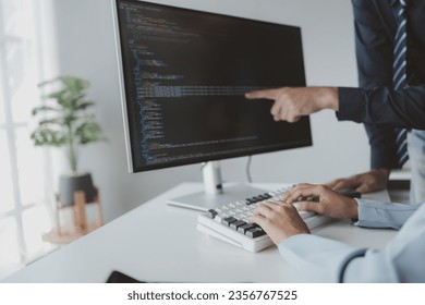 Two programmers looking at computer screen, programmer design custom computer programming, programming code and website. Computer programming design concepts.
