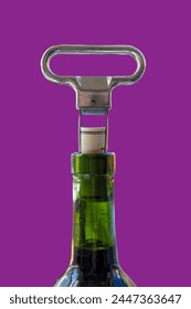Two prong cork puller and cork halfway pulled from green wine bottle