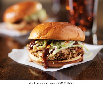two pulled pork bbq sandwiches with cole slaw