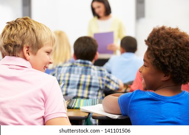 Two Pupils Talking In Class Together