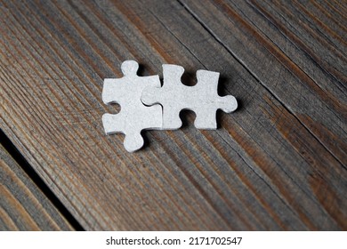Two Puzzles On A Wooden Table. Two Puzzles Side By Side But Do Not Fit Together. Two Different Pieces Of The Puzzle. Puzzles Do Not Make A Difference.