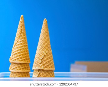 Two pyramids of empty ice-cream cones against blur background. Official state food of Missouri. Closeup. Selective focus