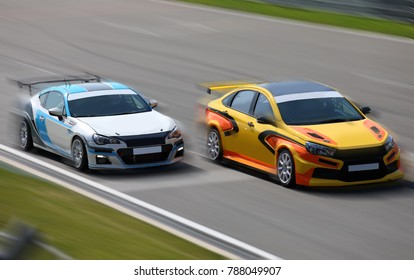 Two Race Cars Racing At High Speed On Speed Track With Motion Blur At Sunny Day On A Racing Track
