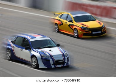 Two Race Cars Racing At High Speed On Speed Track With Motion Blur On A Racing Track
