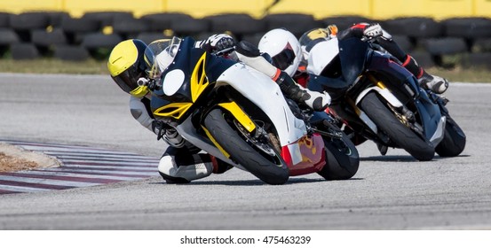 Two racing motorcycles on a sharp bend