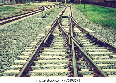 Two railways tracks merge close up.Vintage tone