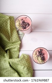 Two Raspberry Smoothies With Hemp Seed And Cocoa Bean Topping On White Wooden Background. Flatlay, Top View