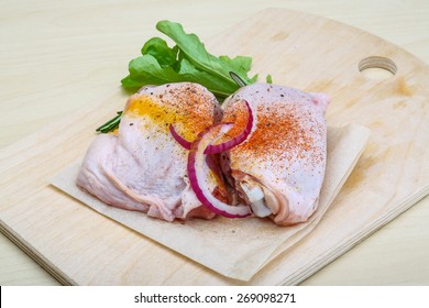 Two Raw chicken thights with herbs and spices