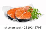 Two raw salmon steaks on plate with parsley isolated on white, accurate clipping path embedded.



