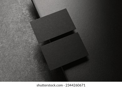 Two real black business cards on elegant dark background, Empty template for luxury stationery mockup