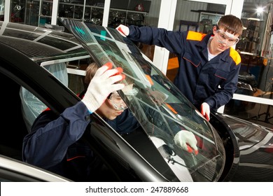 Two Real Mechanics Working In Auto Repair Shop