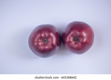 two red apples next to each other