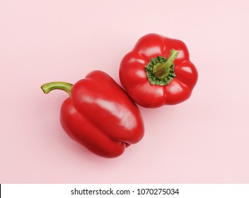 Two Red Bell Peppers Isolated On Pink Background. Minimal Healthy Food Concept. Detox Menu Set, Spicy Meal Veg Fruit Cook. Art Design Card Shot Above Table. Flat Lay View Close Up Copy Space For Text.