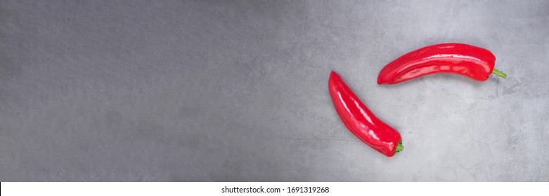 two red bell peppers on concrete background with place for text. Potence symbol. Flat lay - Shutterstock ID 1691319268