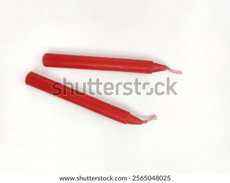 Two red candlesticks on a white background. copy space. top view.