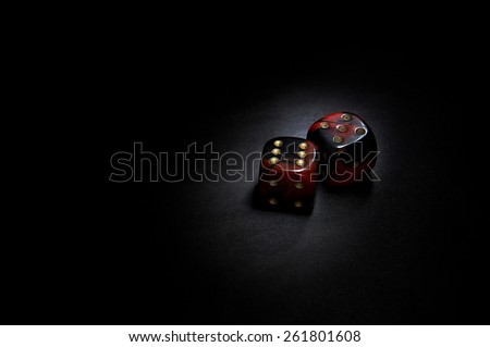 Two red casino dices on the black background
