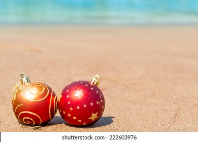 Two Red Christmas Ball On The Beach