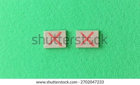 Two red crosses symbolize errors or incorrect choices on a vibrant green. Perfect for projects needing visual error indicators.