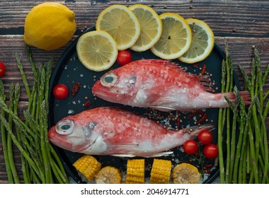 two red fish with vegetables